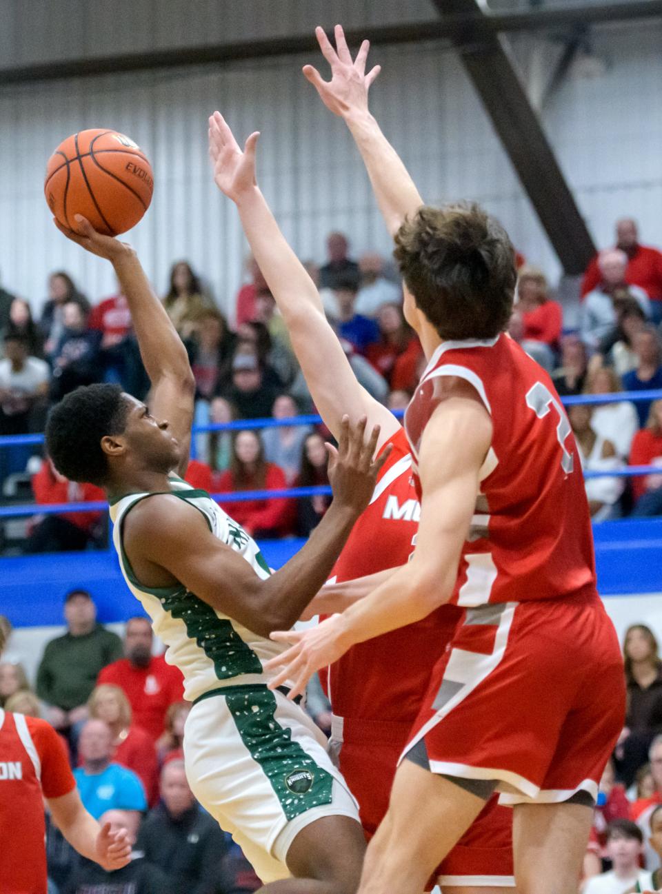 Richwoods' Jared Jackson (5) tries to get a shot over the Morton defense n in the first half of their Class 3A regional basketball title game Friday, Feb. 23, 2024 at Limestone High School in Bartonville. Richwoods advanced to the sectionals with a 56-53 win.