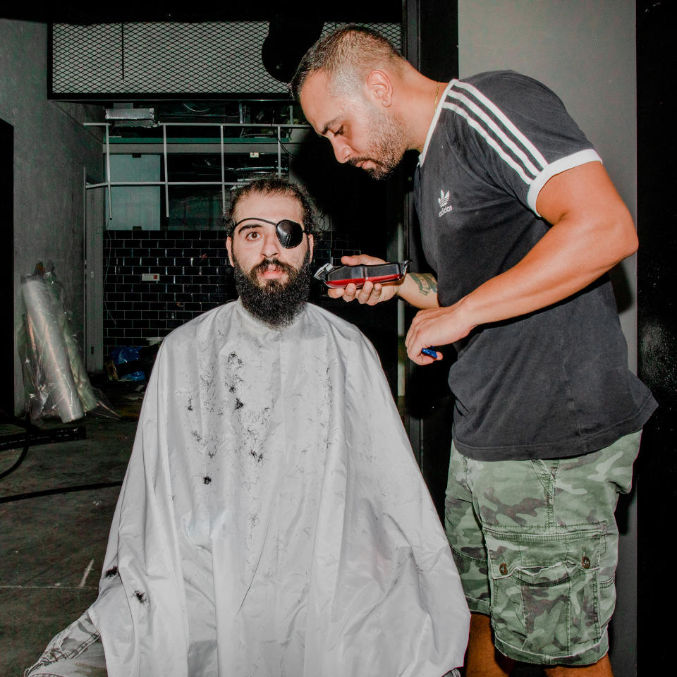 Kevin Obeid cuts Jad Estephan’s hair in the Mar Mikhael area of Beirut on Aug. 7, three days after the deadly port explosion. 