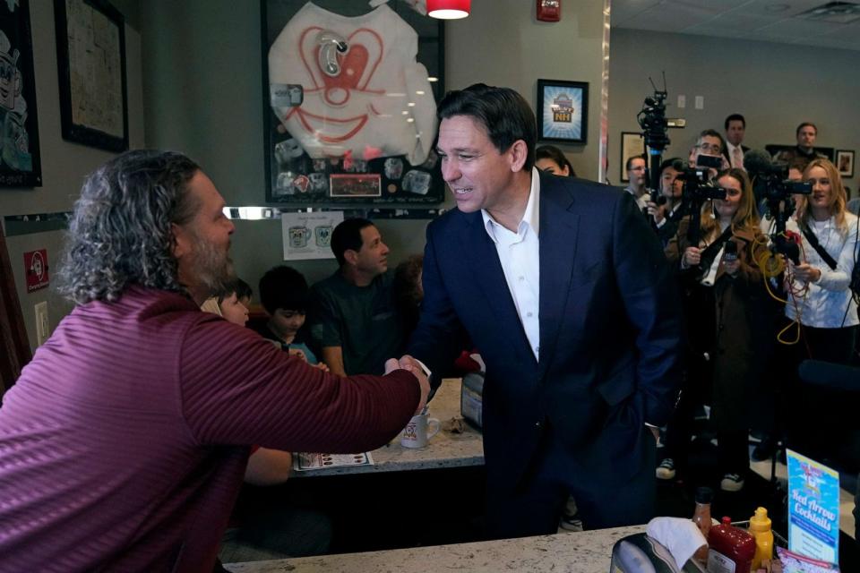 PHOTO: Republican presidential candidate, Florida Gov. Ron DeSantis, shakes hands with a guest during a campaign stop at a diner, Oct. 24, 2023, in Londonderry, N.H. (Charles Krupa/AP)