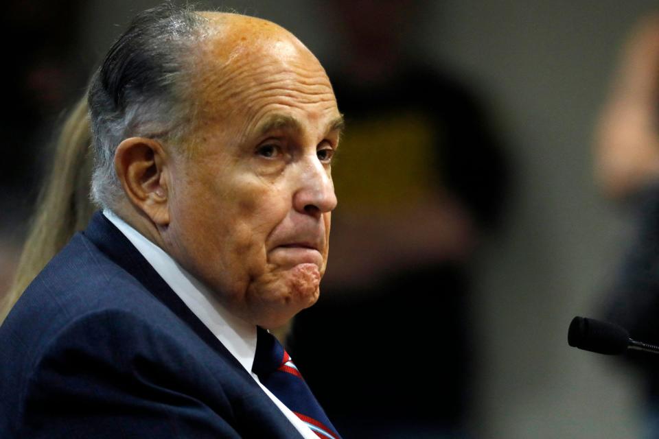 In this file photo taken on December 02, 2020, Rudy Giuliani, personal lawyer of US President Donald Trump, looks on during an appearance before the Michigan House Oversight Committee in Lansing, Michigan.