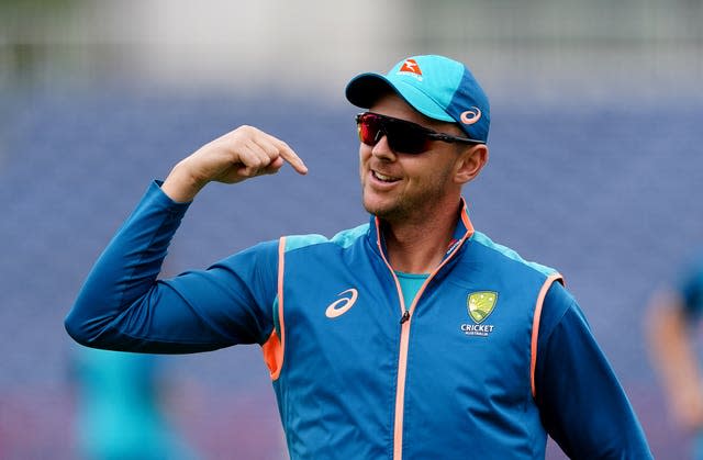 Australia seamer Josh Hazlewood points to his shoulder during a training session