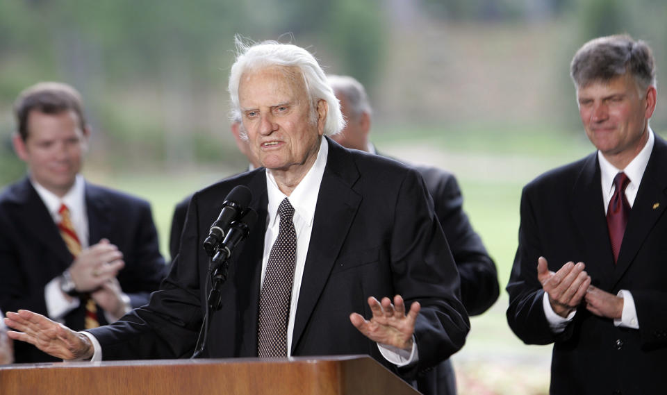 Billy Graham speaks as his son Franklin Graham, right, listens during a dedication ceremony for the Billy Graham Library, May 31, 2007 in Charlotte, N.C.. A statue of the late Rev. Billy Graham set to stand inside the U.S. Capitol to represent North Carolina will be unveiled next week in a ceremony. (AP Photo/Gerry Broome)