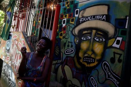 Solange, a worker at Pousada Favelinha (Little favela) hostel, stands near an entrance, in Pereira da Silva favela in Rio de Janeiro, Brazil, April 21, 2016. REUTERS/Pilar Olivares