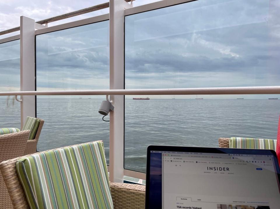 The author sits at an empty table on the Carnival Vista.