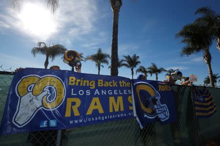 NFL fans Tom Bateman (L-R), 43, Skye Sverdlin, 36, Daniel Balma, 36, and Joe Ramirez, 54, show their support for the St. Louis Rams NFL team to come to Los Angeles at a news conference to unveil plans for development at the site of the former Hollywood Park Race Track in Inglewood, Los Angeles, California, January 5, 2015. REUTERS/Lucy Nicholson