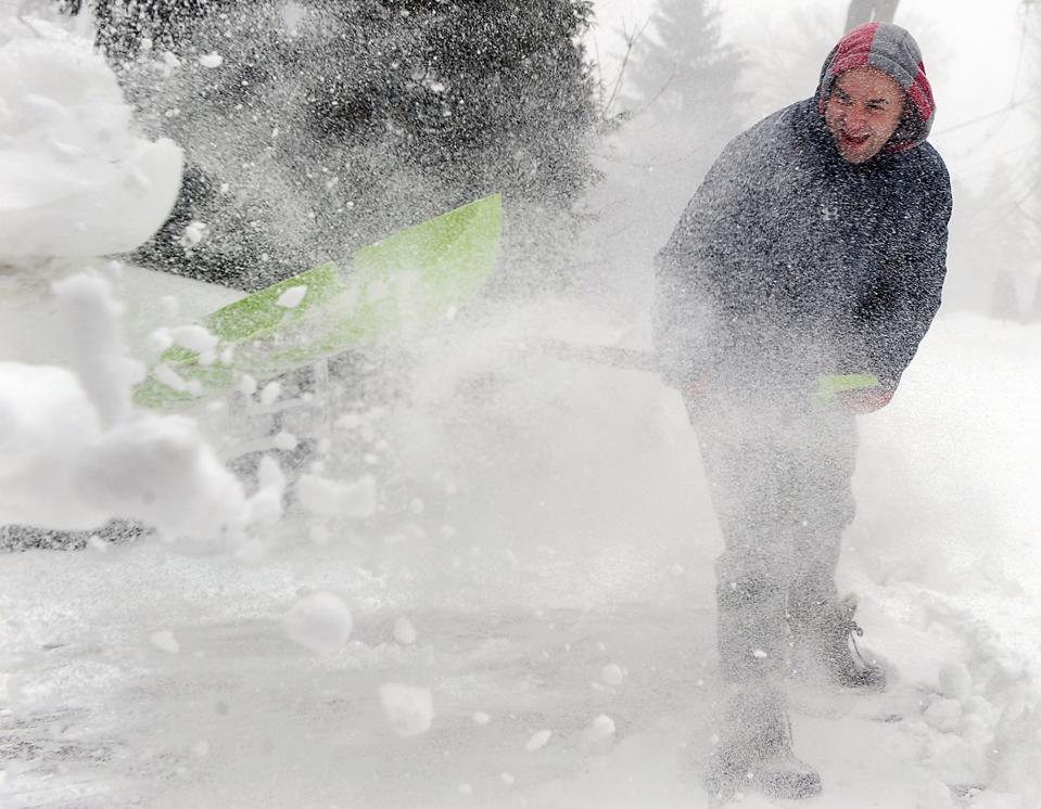 Bradley Rhoton, of Framingham, shovels snow from his Millwood Street driveway during the snowstorm, Jan. 29, 2022.