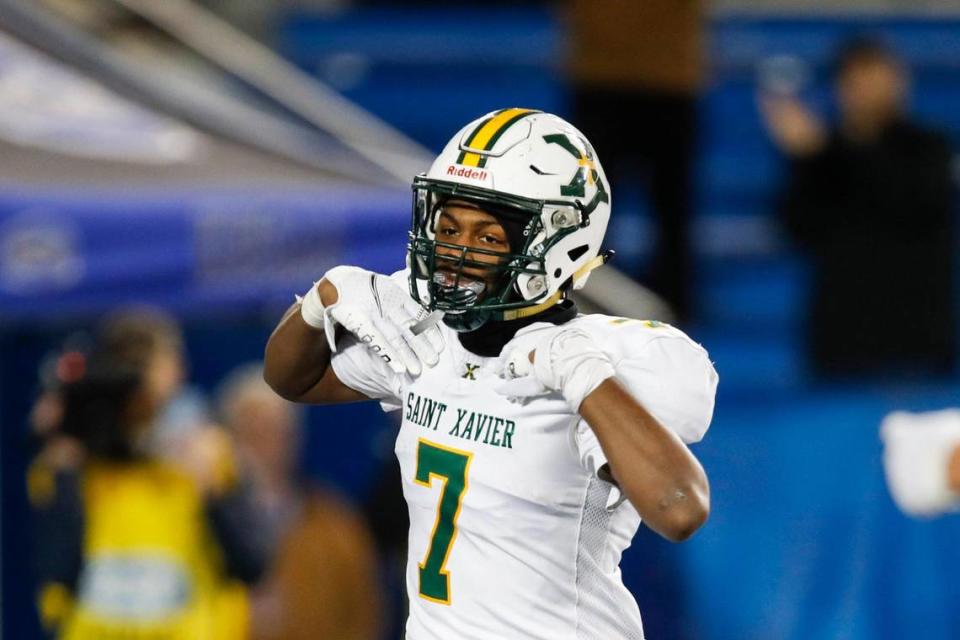 St. Xavier’s Mekhi Smith (7) celebrates after scoring on a 45-yard touchdown reception with 1:52 left in Saturday night’s Class 6A state championship game.