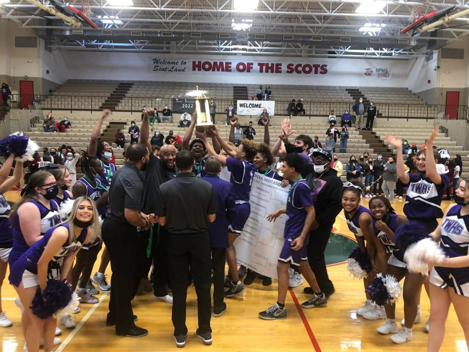 Topeka West celebrates its first Topeka Invitational Tournament win since 2004 on Saturday.