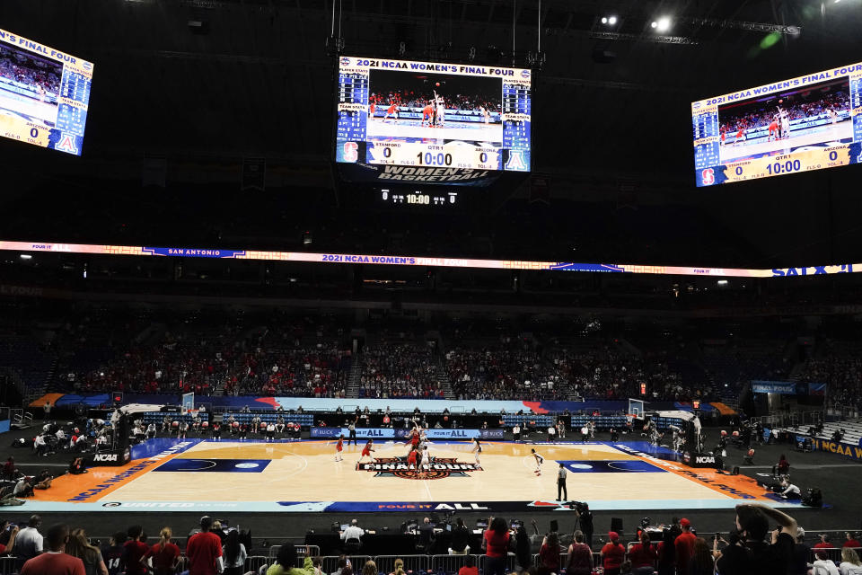 FILE - Players get set for the opening tipoff of the championship game between Stanford and Arizona in the women's Final Four NCAA college basketball tournament in San Antonio, in this Sunday, April 4, 2021, file photo. A law firm hired to investigate gender equity concerns at NCAA championship events released a blistering report Tuesday, Aug. 3, 2021, that recommended holding the men's and women's Final Fours at the same site and offering financial incentives to schools to improve their women's basketball programs. (AP Photo/Morry Gash, File)