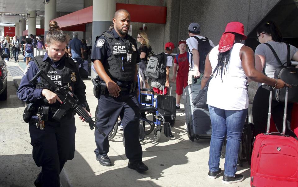 A heavy police presence was at the Ft. Lauderdale-Hollywood International Airport after it re-opened Saturday, Jan. 7, 2017. Investigators continued their work downstairs in the baggage area of terminal 2 the day after a shooting. (Mike Stocker /South Florida Sun-Sentinel via AP)