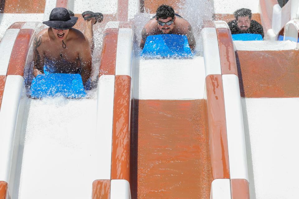 Guests slide down the Storm Chaser at Hurricane Alley Waterpark Saturday, May 28, 2022.