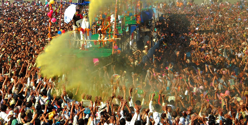 Sant Shri Asaram Bapu sprinkling colored water on his thousands of followers as part of Holi celebrations in Kumbh Mela on March 9, 2013 in Allahabad, India.