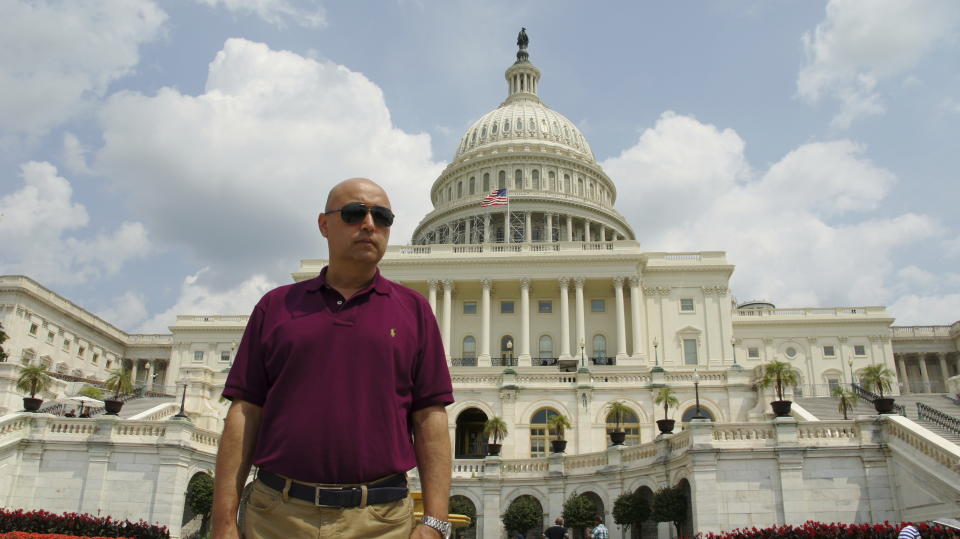 This Aug. 11, 2014, photo provided by his family shows Yalqun Rozi during a family trip to Washington. Rozi is one of over four hundred prominent Uighur academics, writers, performers and artists who have been detained, according to advocacy groups, joining an estimated one million people or more held in internment camps and prisons in China’s far western region of Xinjiang. (AP Photo/Yalqun Family)