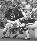 FILE - Chicago Bears' Dick Butkus (51), Doug Buffone (55) and Joe Taylor (20) stop Detroit Lions running back Steve Owens (36) during an NFL football game Nov. 21, 1971, in Chicago. Butkus, a fearsome middle linebacker for the Bears, has died, the team announced Thursday, Oct. 5, 2023. He was 80. According to a statement released by the team, Butkus' family confirmed that he died in his sleep overnight at his home in Malibu, Calif. (AP Photo/Fred Jewell)