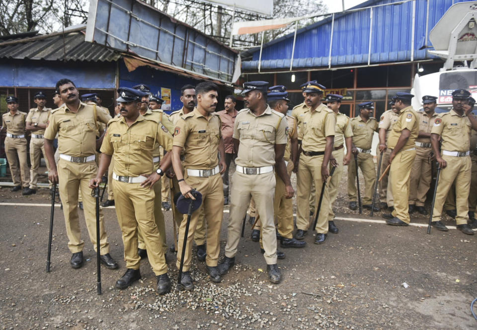 Indian policemen are deployed to guard against protestors who are opposed to allowing women of menstruating age from entering the Sabarimala temple at Nilackal, a base camp on way to the mountain shrine in Kerala, India, Wednesday, Oct. 17, 2018. The historic mountain shrine, one of the largest Hindu pilgrimage centers in the world is set to open its doors to females of menstruating age following a ruling by the country's top court. Police arrested some protesters when they tried to block the path of some females. (AP Photo)