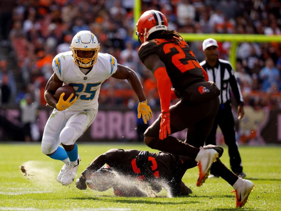 Joshua Kelley stares down a defender against the Cleveland Browns.