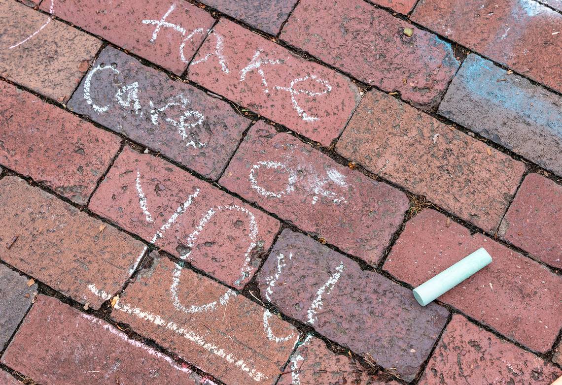 Messages are written in chalk on the quad of UNC-Chapel Hill on Tuesday, Aug. 29, 2023, following a Monday shooting that left a faculty member dead on the university campus. 