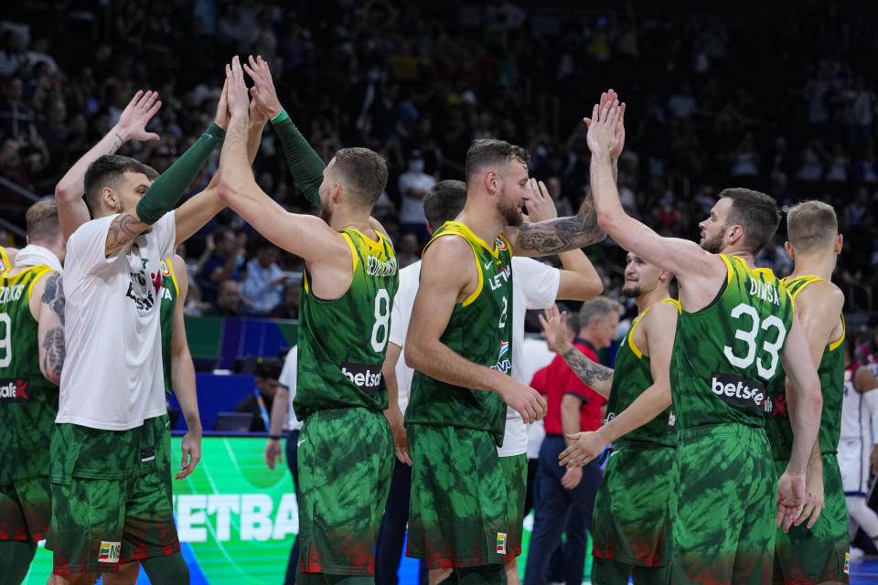 Lithuania celebrates after defeating the United States in a Basketball World Cup second-round match in Manila, Philippines Sunday, Sept. 3, 2023.(AP Photo/Michael Conroy)