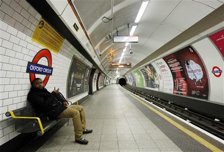 A passenger waits for a tube train that did not arrive on an empty platform during rush hour at Oxford Circus underground station in London February 5, 2014. REUTERS/Luke MacGregor