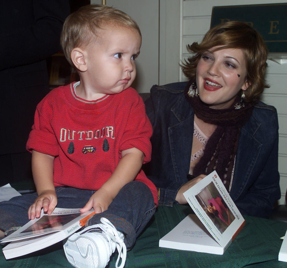 Actress Drew Barrymore poses with nineteen month old Nicholas
Mittelbach during a book signing promoting her new film "Riding in Cars
with Boys" October 5, 2001 in Los Angeles. Barrymore signed copies of
the book by the same name authored by Beverly Donofrio who also
participated in the event. The film opens October 19 in the United
States. REUTERS/Rose Prouser REUTERS

RMP