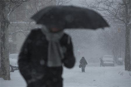 Commuters make their way through heavy snow in Downtown Manhattan, New York