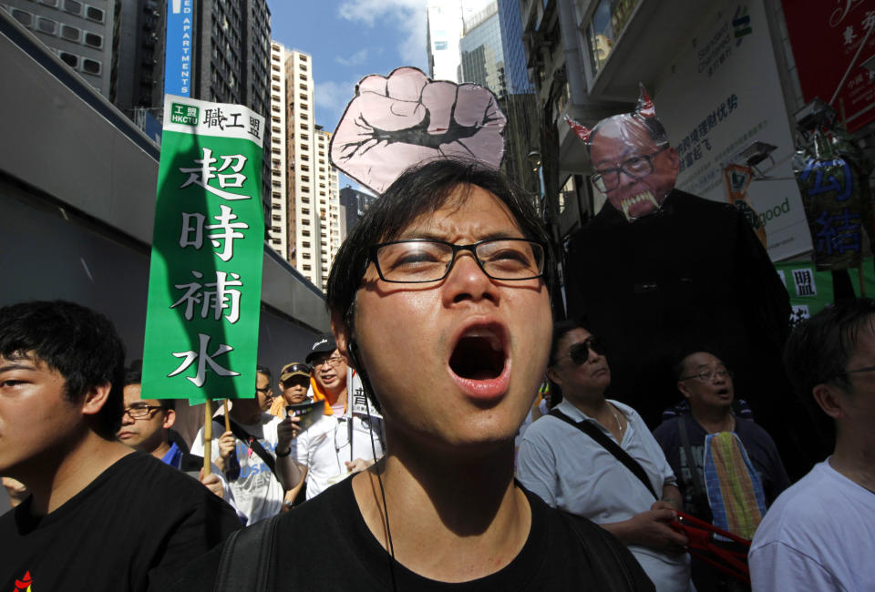 In this July 1, 2011, file photo, a protester shouts slogans as thousands of people march in Hong Kong's downtown street. A national security law enacted in 2020 and COVID-19 restrictions have stifled major protests in Hong Kong including an annual march on July 1. (AP Photo/Vincent Yu, File)
