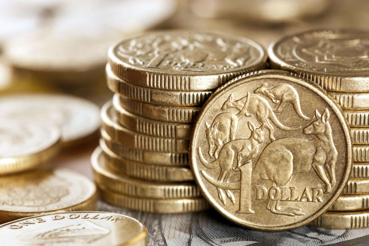 Stacks of Australian one dollar coins.  Focus on front coin.