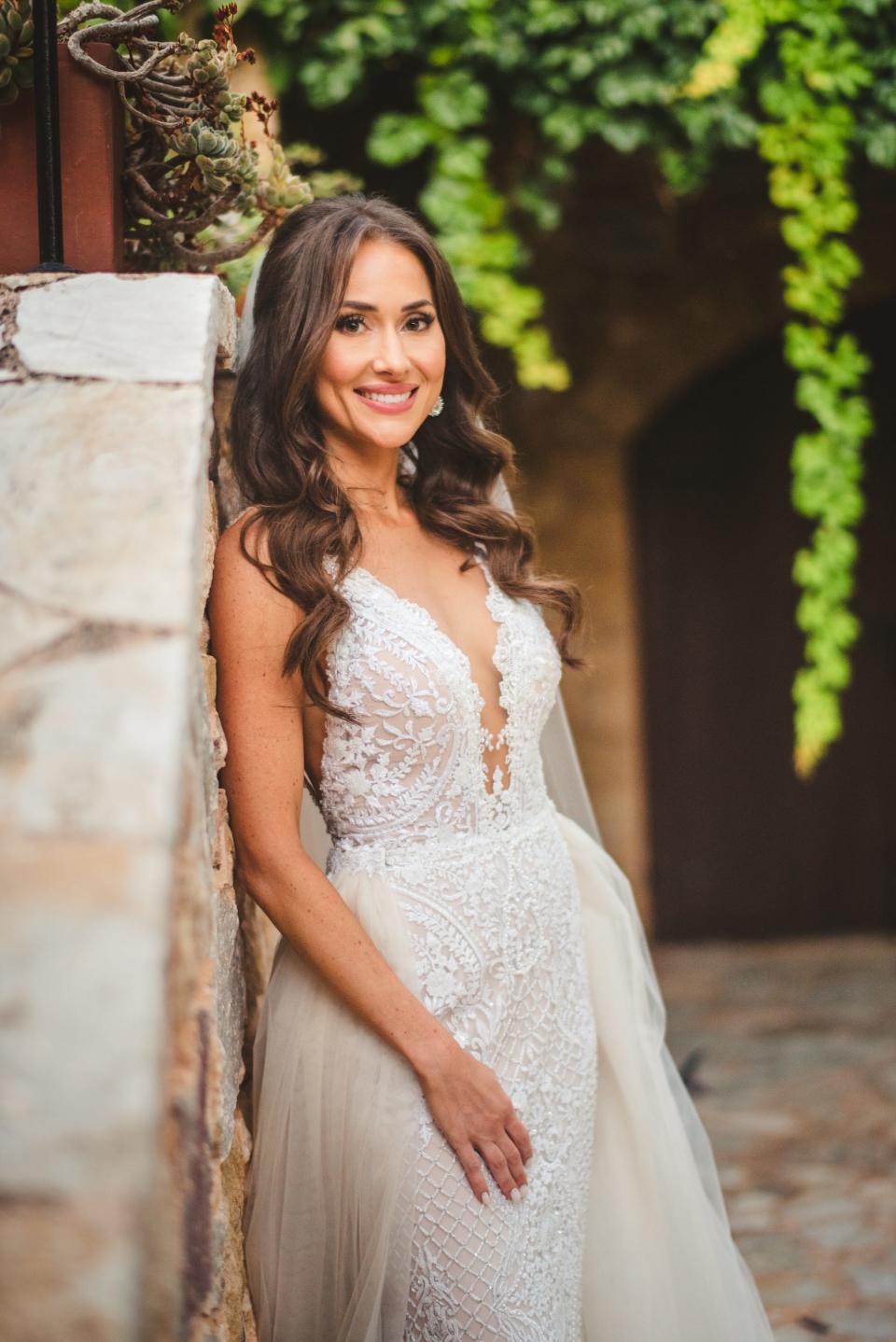 A bride smiles in her wedding dress.