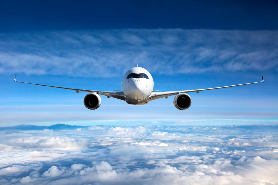 Large airplane flying high above the clouds.