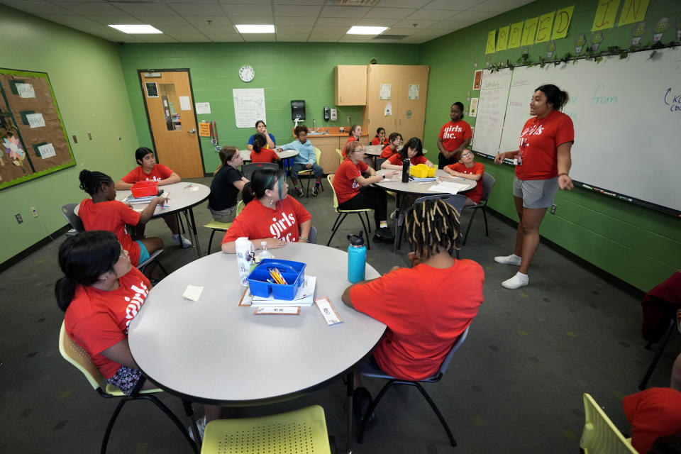 Program Specialist Andrea Vazquez, right, leads a class discussion during a Lean In session at Girls Inc., Wednesday, July 26, 2023, in Sioux City, Iowa. A new girls leadership program from Lean In, the organization launched after Sheryl Sandberg published her book “Lean In: Women, Work and the Will to Lead,” will help girls respond to biases and gender inequities they may face. (AP Photo/Charlie Neibergall)