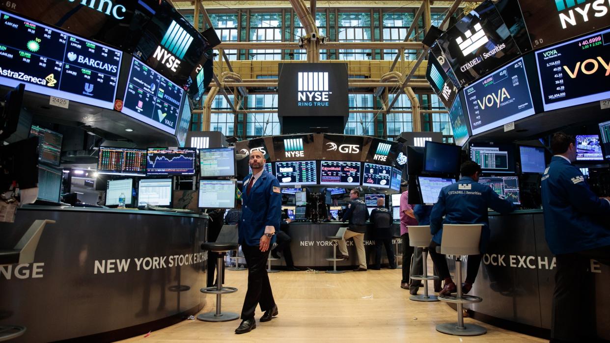 Traders and financial professionals work on the floor of the New York Stock Exchange (NYSE)