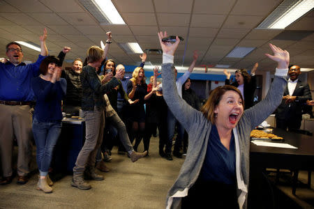 Amber Hunt, reporter Cincinnati Enquirer (R) and other journalists in the Enquirer newsroom celebrate as they learn of winning a Pulitzer Prize for local reporting for their "Seven Days of Heroin" project in Cincinnati, Ohio, U.S. April 16, 2018. Cara Owsley/The Enquirer via USA TODAY NETWORK