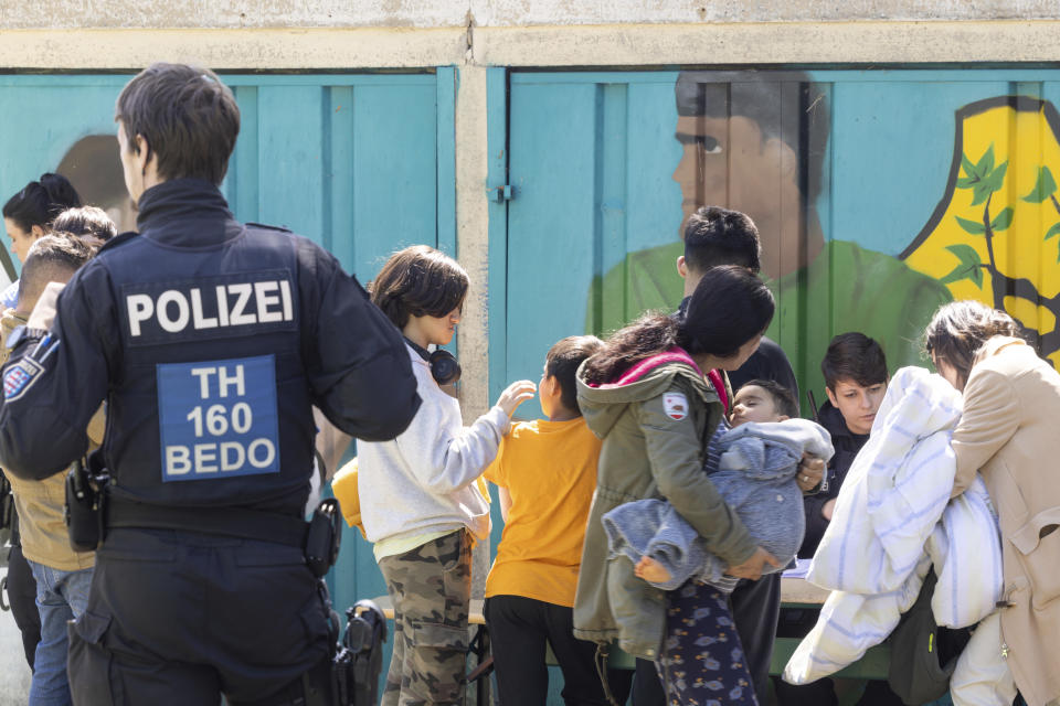 Refugees are evacuated after a fire broke out in a refugee shelter in Apolda, Germany, Sunday June 4, 2023. Police said the fire broke out around 5 a.m. Sunday and that one person had died. A local government spokesperson said the shelter housed 300 people and was evacuated. (Michael Reichel/dpa via AP)