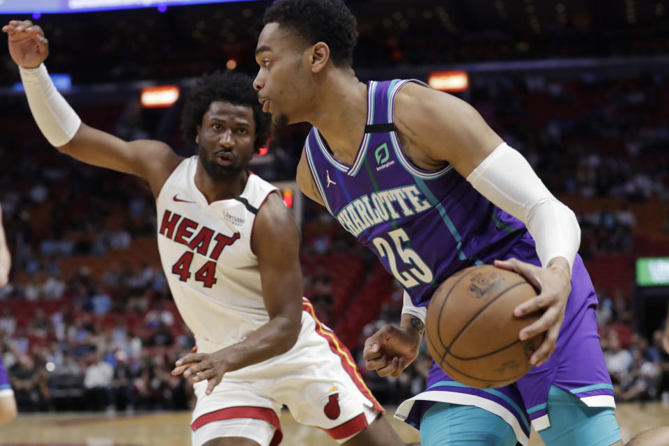 Charlotte Hornets forward PJ Washington Jr. (25) drives to the basket past Miami Heat forward Solomon Hill (44) during the first half of an NBA basketball game, Wednesday, March 11, 2020, in Miami. (AP Photo/Wilfredo Lee)