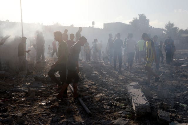 Palestinians inspect the damage of a destroyed mosque after an Israeli airstrike in Khan Younis refugee camp, southern Gaza Strip, on Wednesday