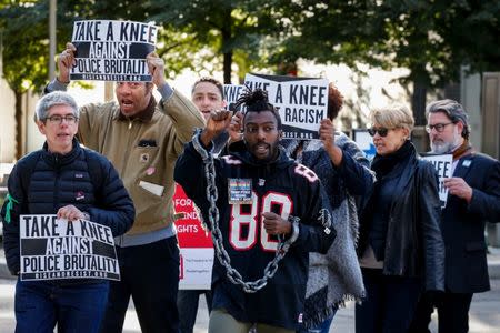 Demonstrators rally outside the NFL owners meeting in New York City, NY, U.S. October 17, 2017. REUTERS/Brendan McDermid