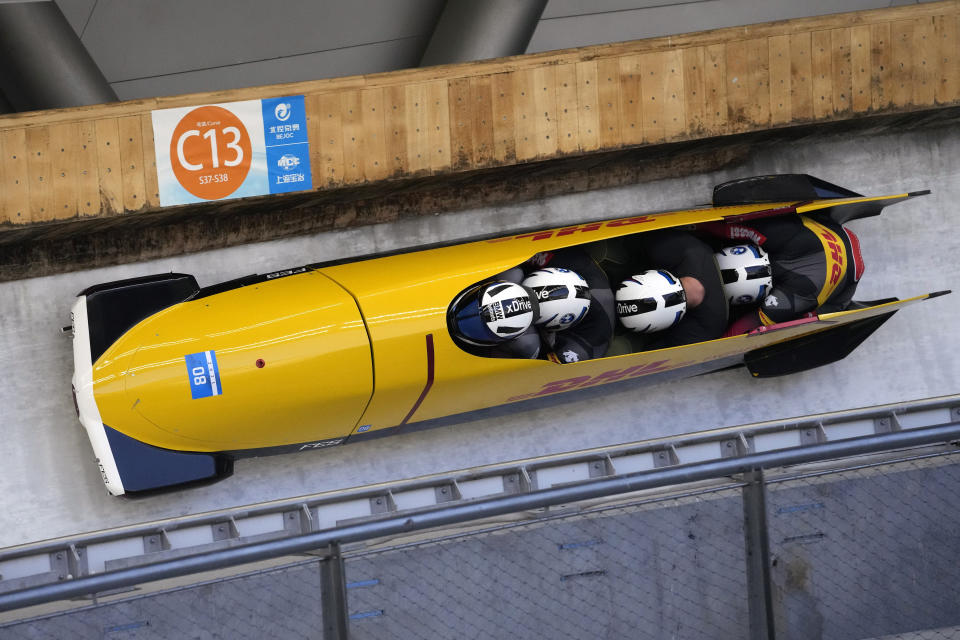 Francesco Friedrich, Thorsten Margis, Candy Bauer, and Alexander Schueller of Germany compete in the four-man bobsleigh during an IBSF Sanctioned Race, a test event for the 2022 Winter Olympics, at the Yanqing National Sliding Center in Beijing, Tuesday, Oct. 26, 2021. (AP Photo/Mark Schiefelbein)