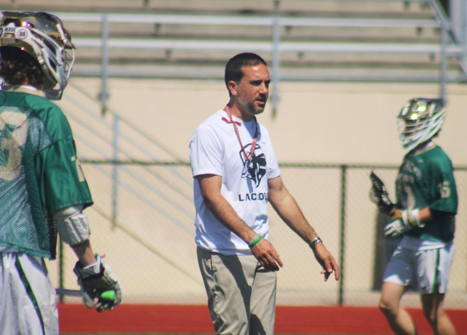 Nease head coach Max Gurowski issues instructions to his players before Saturday's Rivalry on the River high school boys lacrosse tournament against Tallahassee Maclay.