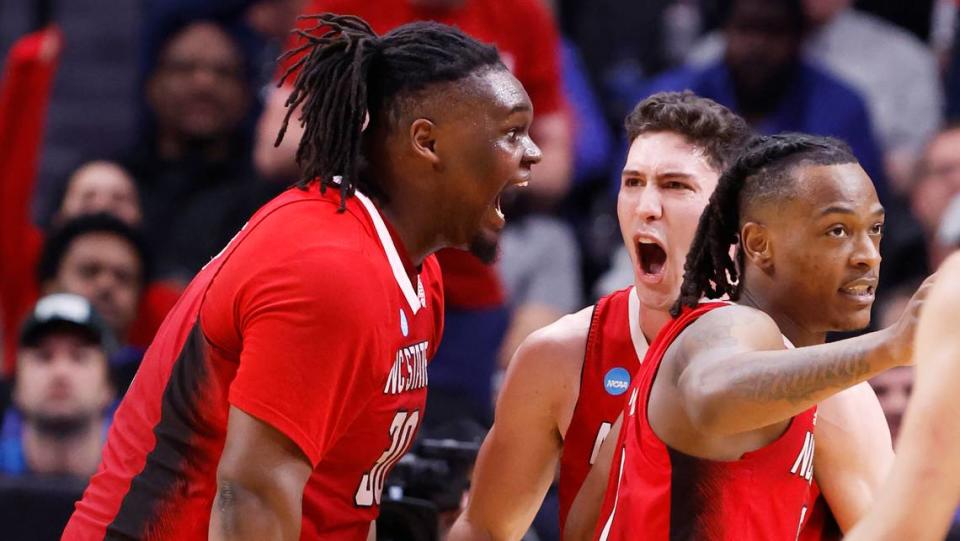 NC State’s DJ Burns and Michael McConnell celebrate a Wolfpack basket late in the NCAA Elite 8 game against Duke.