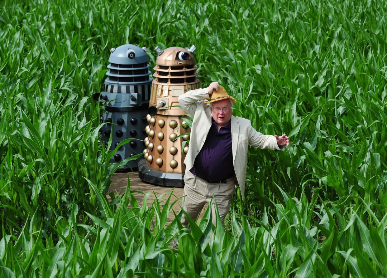 Colin Baker, the sixth Doctor, runs from the Daleks during a photocall to launch the 2013 York Maze which this year celebrates 50 years of the television series Doctor Who.   (Photo by Anna Gowthorpe/PA Images via Getty Images)