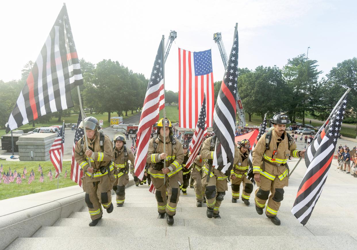 First responders begin to climb the steps of the McKinley National Memorial on Monday during an event commemorating those lost in the Sept. 11, 2001, attacks.