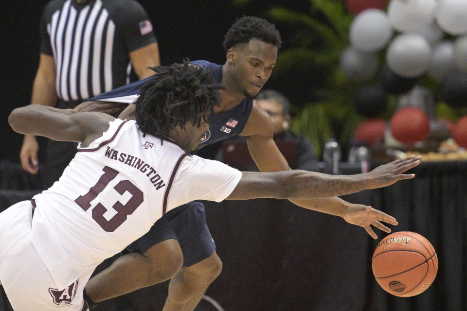 Texas A&M forward Solomon Washington (13) and Penn State guard Kanye Clary battle for a loose ball during the first half of an NCAA college basketball game, Thursday, Nov. 23, 2023, in Kissimmee, Fla. (AP Photo/Phelan M. Ebenhack)