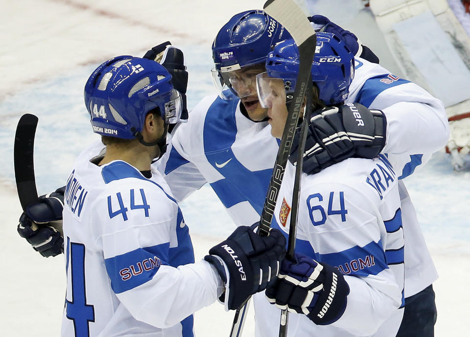 Team Finland celebrates a first period goal against Austria during a men's ice hockey game at the 2014 Winter Olympics, Thursday, Feb. 13, 2014, in Sochi, Russia. (AP Photo/Mark Humphrey)