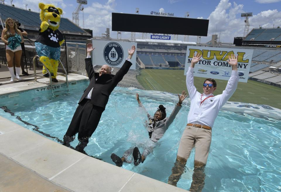 Ray Carson, Kayla Auguster and Hampton Graham take the plunge for ALS at TIAA Bank Field Tuesday.
