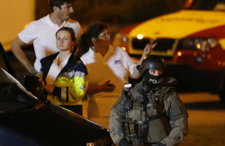 A special force police officer stand guard near the Olympia shopping mall, following a shooting rampage at the mall in Munich. REUTERS/Michael Dalder