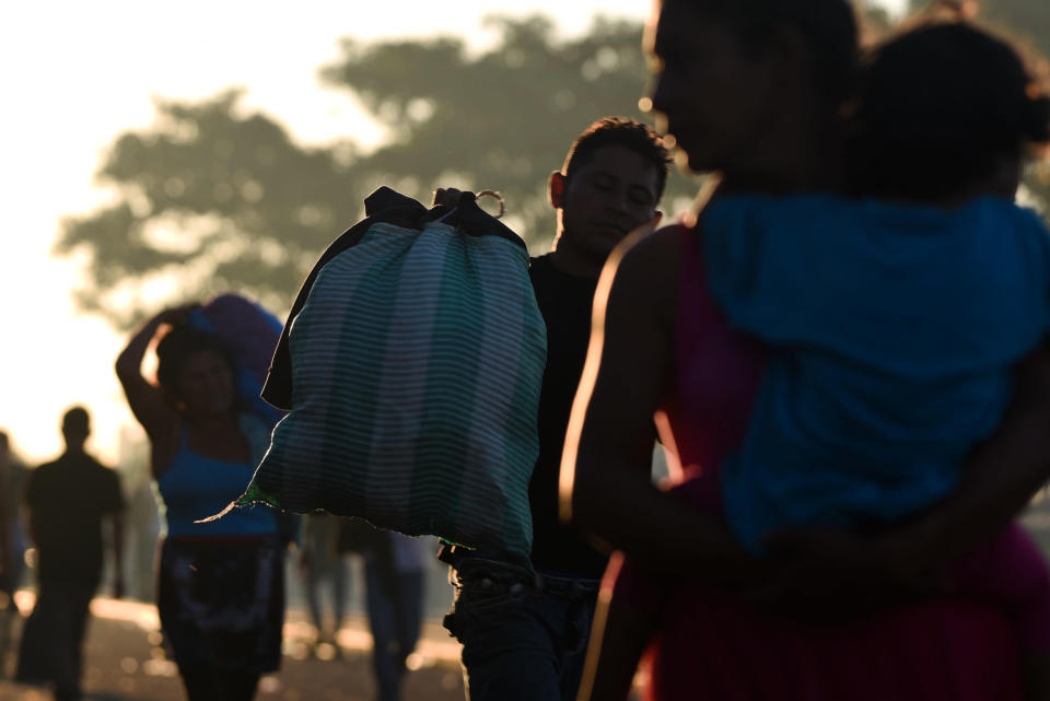 <p>Honduran migrants taking part in a caravan heading to the U.S., wait to cross the border from Ciudad Tecun Uman in Guatemala, to Ciudad Hidalgo, Mexico, on Oct. 22, 2018. President Trump on Monday called the migrant caravan heading toward the U.S.-Mexico border a national emergency, saying he has alerted the U.S. border patrol and the military. (Photo: Orlando Sierra/AFP/Getty Images) </p>