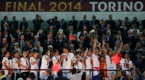 Sevilla's captain Ivan Rakitic holds the Europa League trophy aloft in 2014 as his teammates celebrate alongside him (Photo by John Walton - EMPICS/PA Images via Getty Images)