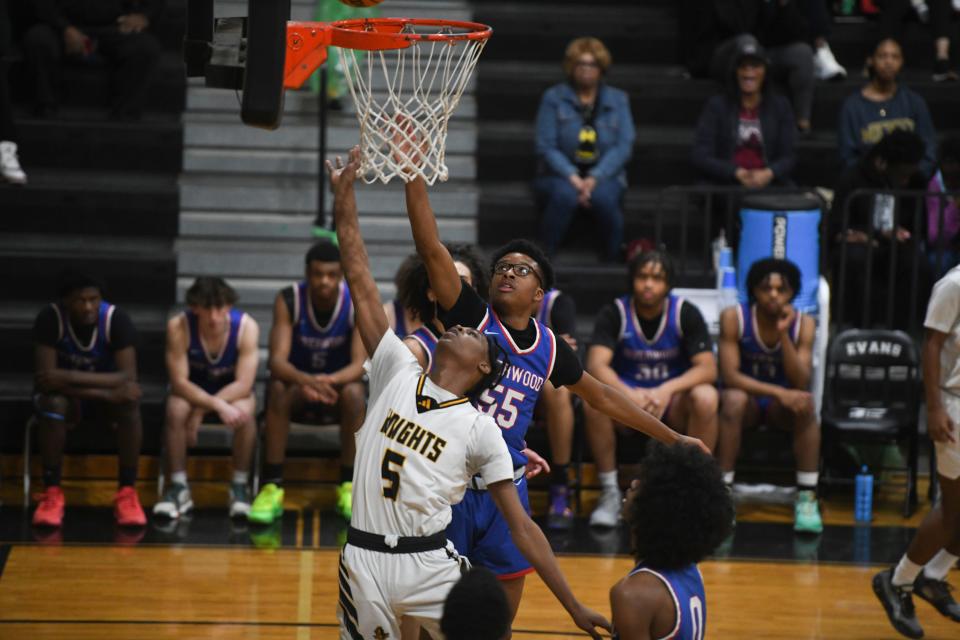 Evans point guard Taj Ford (5) shoots the ball during the Evans and Riverwood 6A playoff game at Evans High School on Saturday, Feb. 24, 2024. Riverwood defeated Evans 95-71.