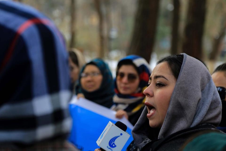 File photo: Afghan women and activists hold a banner during a protest in Kabul on 12 January 2022  (EPA)