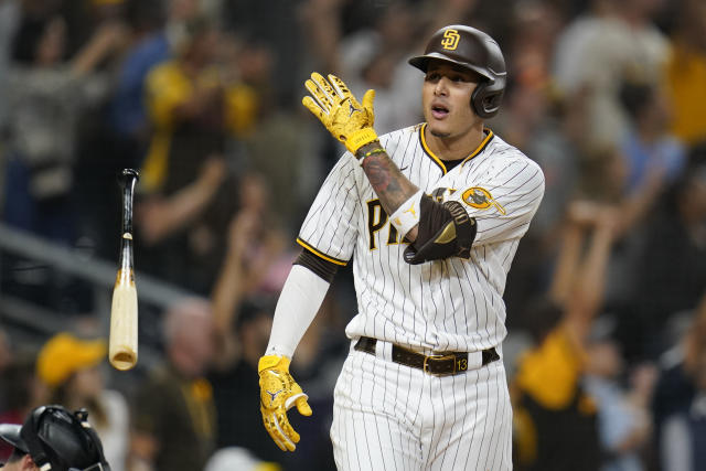 San Diego Padres' Brandon Drury, center, talks with trainers and manager  Bob Melvin (3) after being hit in the helmet by a pitch during the fourth  inning of a baseball game against